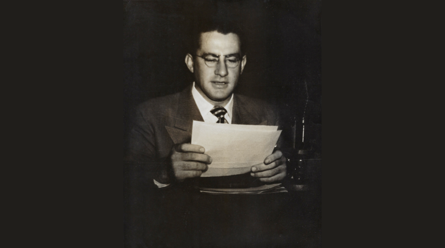 Armand Kovitz reading news in front of microphone