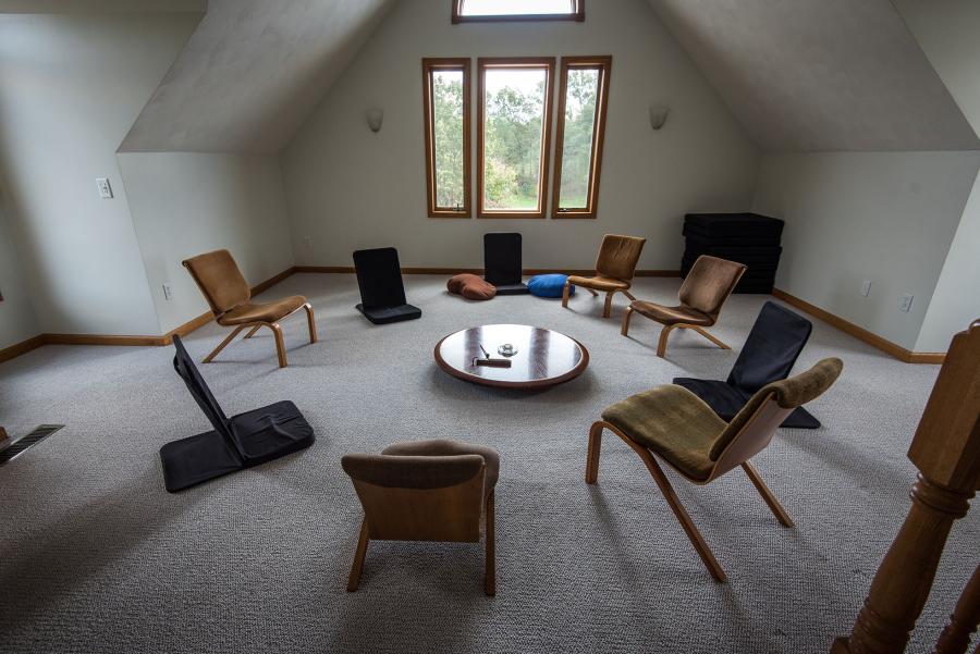 circle of meditation chairs in a white room