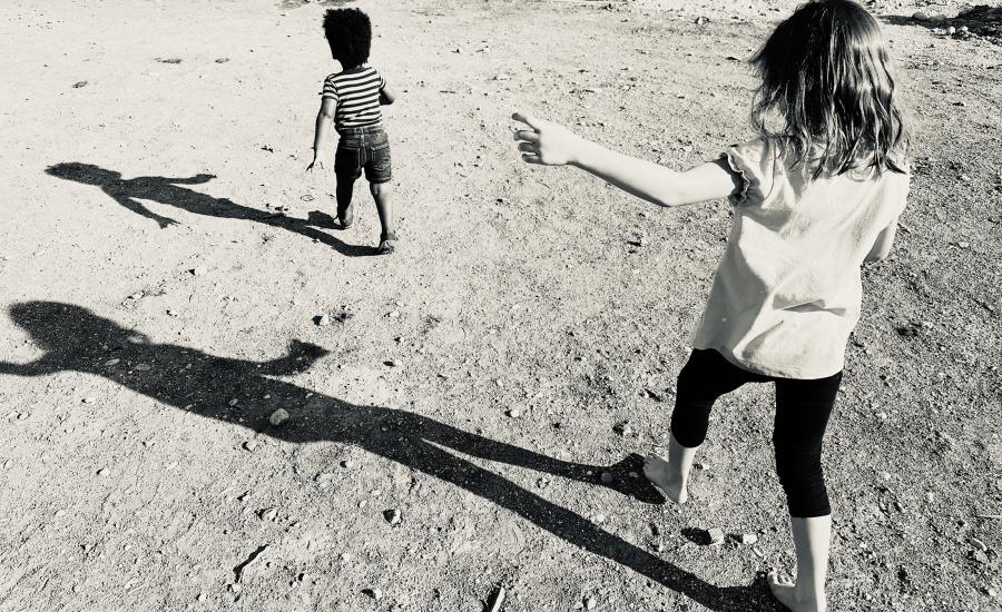 two children running through sand