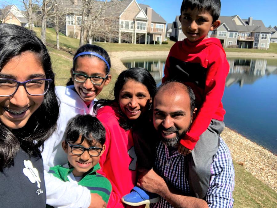 Kurian Thomas and family outdoors in the spring sun