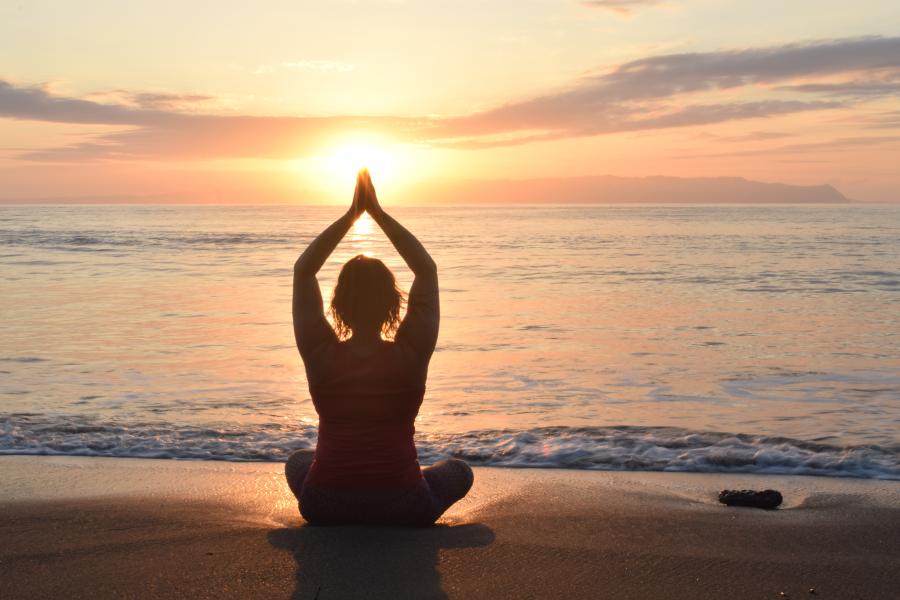 yoga on the beach with sunset