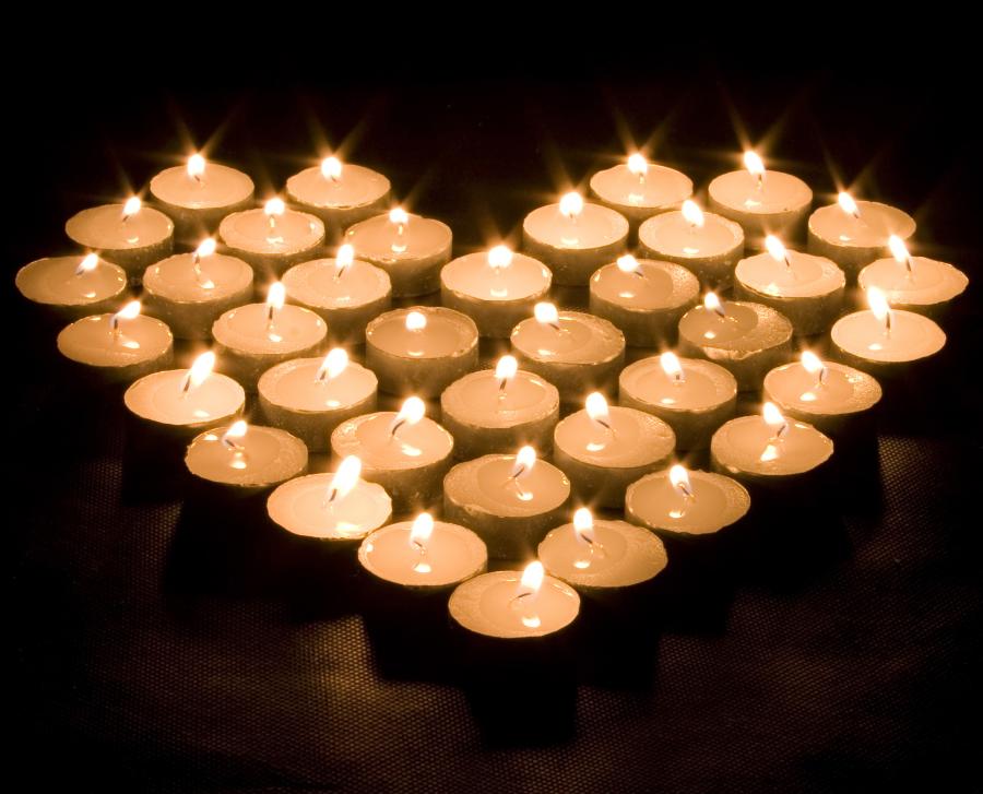 lit votive candles in a heart shape
