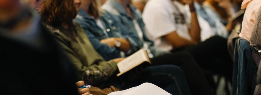 People in church with books on laps