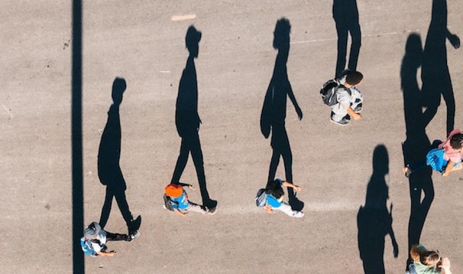 Aerial view of long shadows and people walking