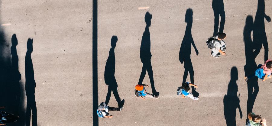 Aerial view of long shadows and people walking