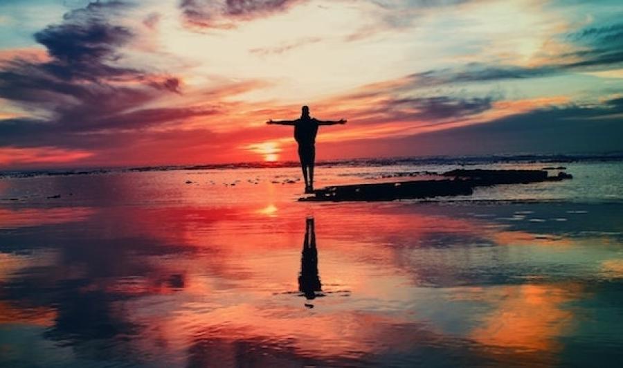 Silhouette of person on shore at sunset in Asilah, Morocco