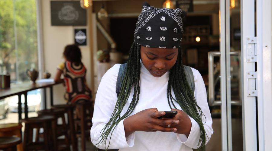 Young woman texting on cell phone