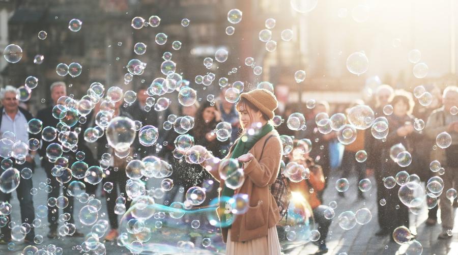 Woman outdoors surrounded by bubbles