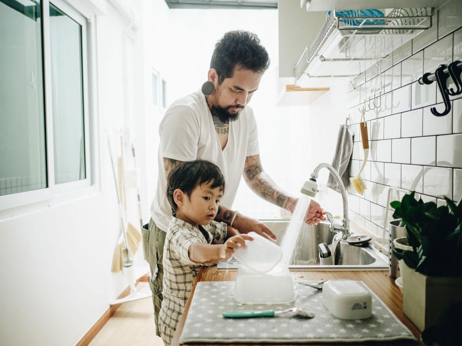 father and son doing dishes at home