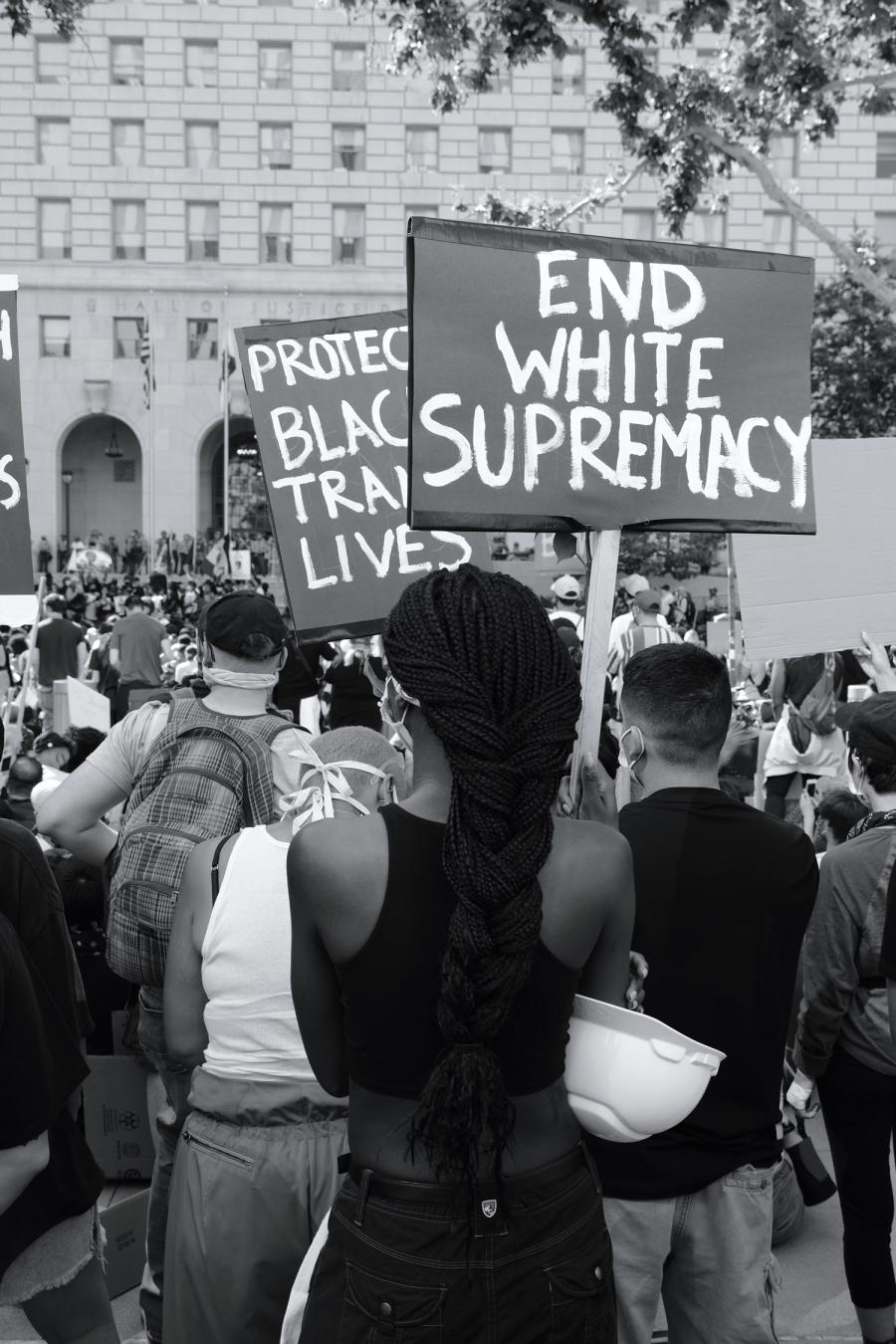 Group protest with sign "end white supremacy"