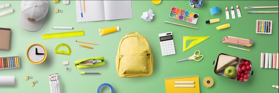 an array of school supplies in green and yellow hues